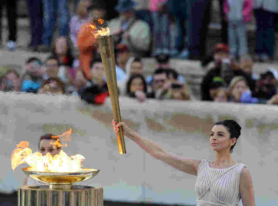 Actress Ino Menegaki, dressed as a high priestess, lights the torch at a ceremony in Panathinean stadium in Athens. Actress Ino Menegaki, dressed as a high priestess, lights the torch at a ceremony in Panathinean stadium in Athens.