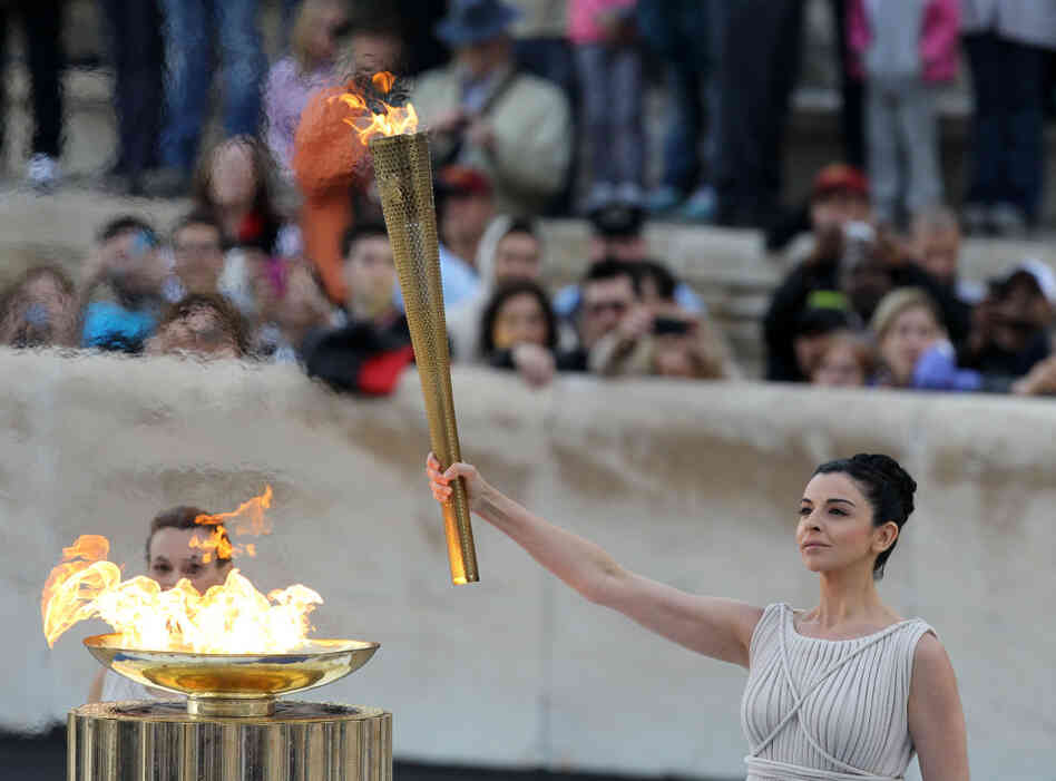 Actress Ino Menegaki, dressed as a high priestess, lights the torch at a ceremony in Panathinean stadium in Athens. Actress Ino Menegaki, dressed as a high priestess, lights the torch at a ceremony in Panathinean stadium in Athens.