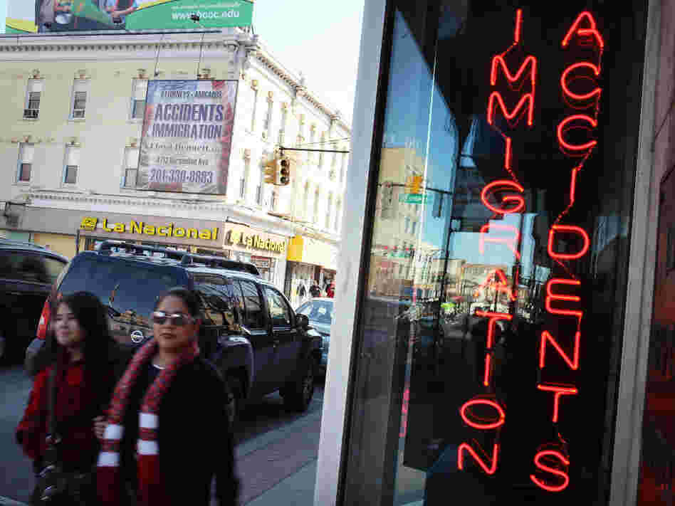 Hispanic residents walk by a law office in Union City, N.J., specializing in immigration in March. Union City is one of the state's largest cities, and has a Hispanic population of more than 80 percent.
