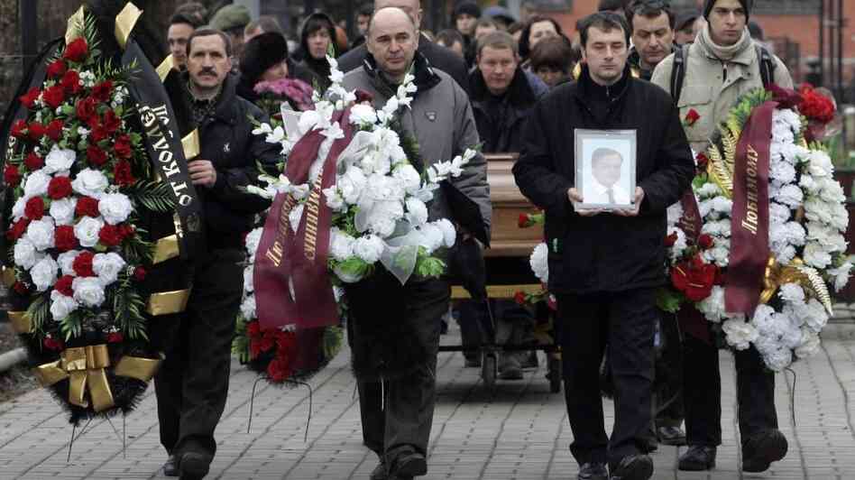 Friends and relatives take part in the funeral ceremony of Sergei Magnitsky at a cemetery in Moscow in 2009. The tax lawyer was arrested after he began investigating fraud at Hermitage Capital, which had been seized by the Russian tax police. He later died in prison. Friends and relatives take part in the funeral ceremony of Sergei Magnitsky at a cemetery in Moscow in 2009. The tax lawyer was arrested after he began investigating fraud at Hermitage Capital, which had been seized by the Russian tax police. He later died in prison.