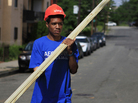 Domingo Williams, a participant in the Sasha Bruce Youthwork program, gathers wood to help rebuild a gutted house in the Southeast neighborhood of Washington, D.C. Domingo Williams, a participant in the Sasha Bruce Youthwork program, gathers wood to help rebuild a gutted house in the Southeast neighborhood of Washington, D.C.