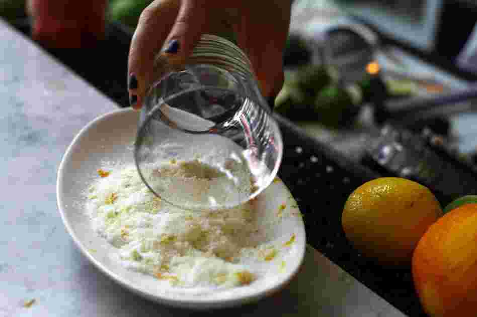 Rub half a lime around the rim of the glass. Dip the rim into the salt. For less salt: Make a lipstick-sized mark on the rim instead of coating the whole thing. Then, tap the outside of the glass in the salt.