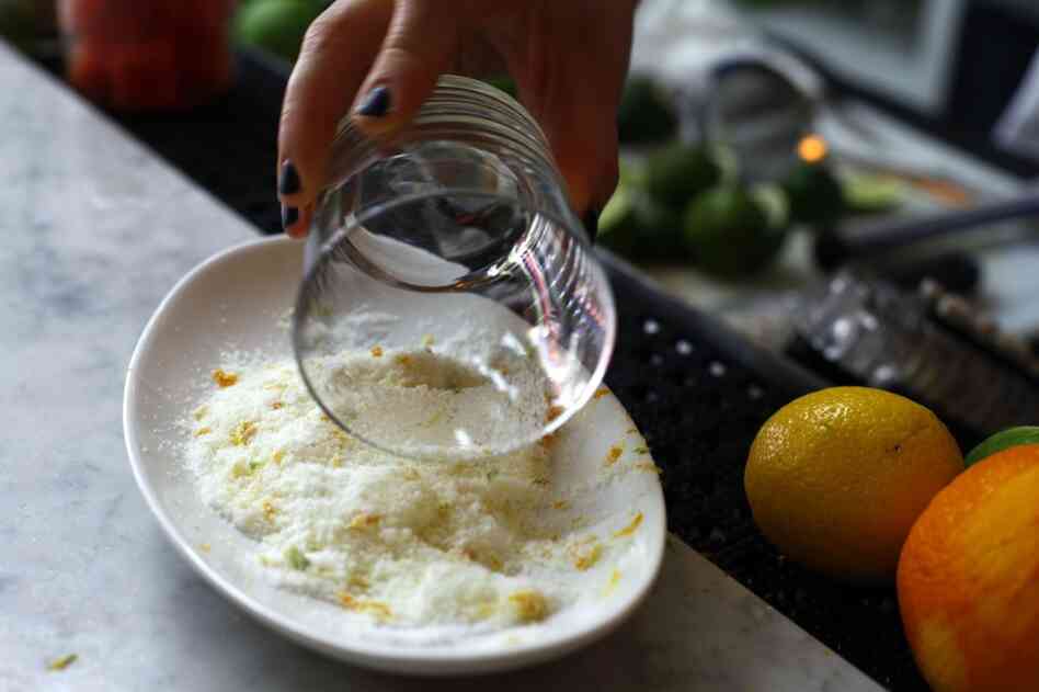 Rub half a lime around the rim of the glass. Dip the rim into the salt. For less salt: Make a lipstick-sized mark on the rim instead of coating the whole thing. Then, tap the outside of the glass in the salt.