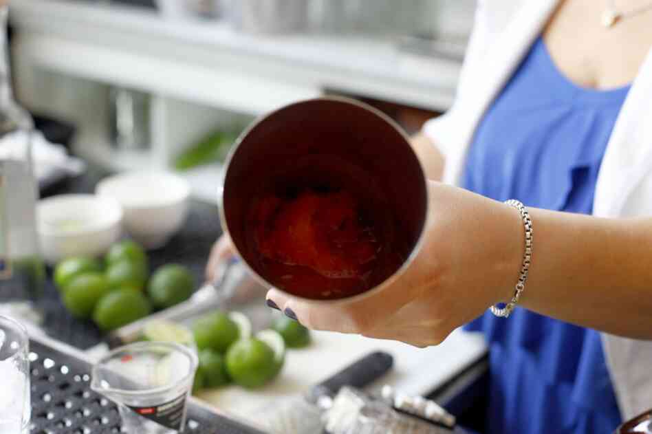 Muddle, or mash down, 4 or 5 cubes of watermelon.