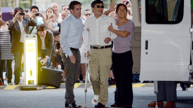 Chinese legal activist Chen Guangcheng, center, arrives at Washington Square Village on the campus of New York University on Saturday in New York. Chen escaped from his village in April and was given sanctuary inside the U.S.