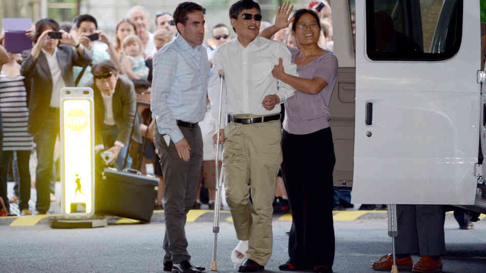 Chinese legal activist Chen Guangcheng, center, arrives at Washington Square Village on the campus of New York University on Saturday in New York. Chen escaped from his village in April and was given sanctuary inside the U.S.