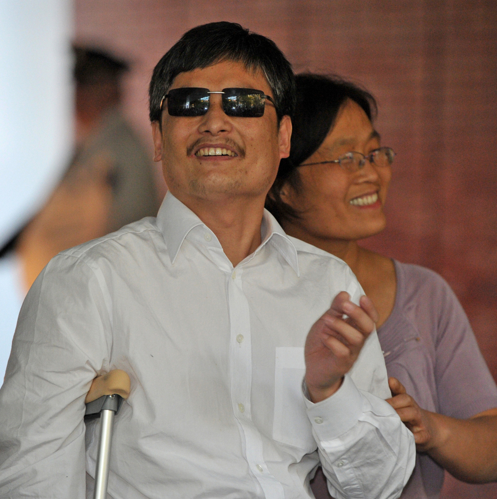 Chinese activist Chen Guangcheng and his wife Yuan Weijing arrive at the New York University Village apartment complex in New York Saturday.