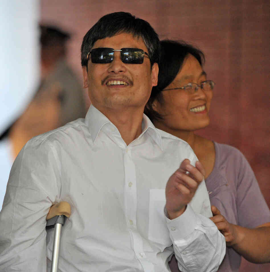 Chinese activist Chen Guangcheng and his wife Yuan Weijing arrive at the New York University Village apartment complex in New York Saturday.