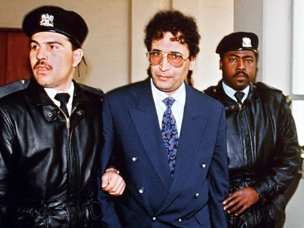Security officers escort convicted Lockerbie bomber Abdel Baset al-Megrahi (center) in Tripoli in 1992.