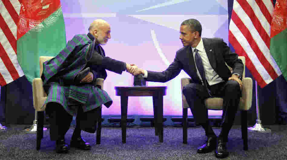 President Obama shakes hands with with Afghan President Hamid Karzai during their meeting at the NATO Summit in Chicago on Sunday. The summit, which continues Monday, is focusing heavily on Afghanistan's future.