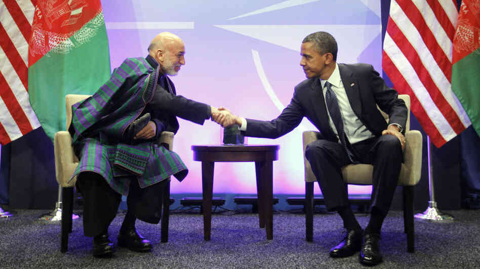 President Obama shakes hands with with Afghan President Hamid Karzai during their meeting at the NATO Summit in Chicago on Sunday. The summit, which continues Monday, is focusing heavily on Afghanistan's future.