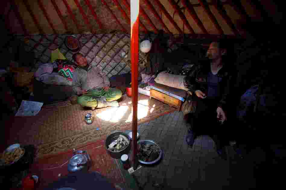 In South Gobi province, a local politician (right) and a herder sit inside a traditional yurt, or ger, and discuss the lack of water in the area. Herdsmen worry that mines — which require massive amounts of water to process ore — will deplete already diminishing supplies.