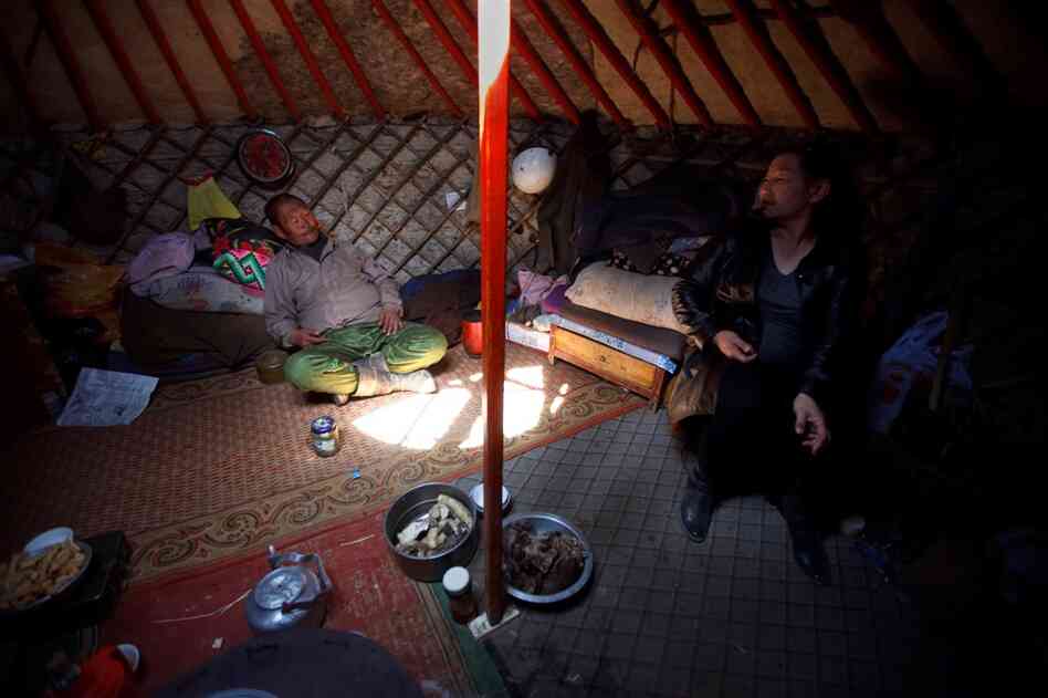In South Gobi province, a local politician (right) and a herder sit inside a traditional yurt, or ger, and discuss the lack of water in the area. Herdsmen worry that mines — which require massive amounts of water to process ore — will deplete already diminishing supplies.