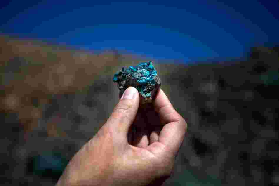 Oyu Tolgoi, a massive mine in Mongolia's South Gobi province, begins producing copper ore in June, 2012. Within five years, it's expected to become the world's third largest copper mine. An employee at Oyu Tolgoi — which means "Turquoise Hill" — holds up a chunk of oxidized copper.