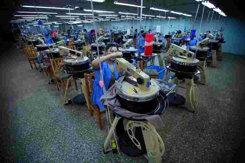 The circular machines on the factory floor are used to make ribbed cloth and sweaters.