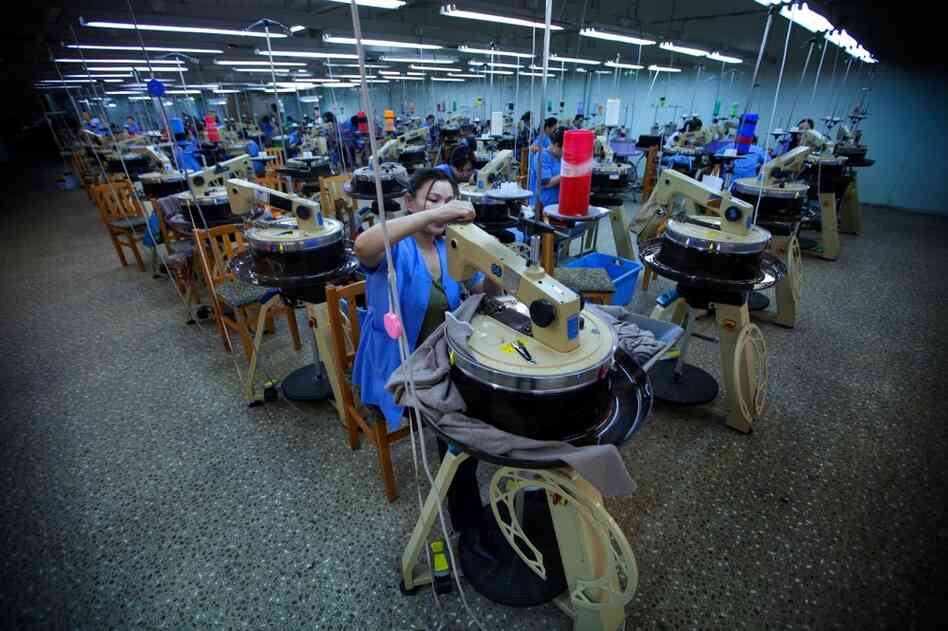 The circular machines on the factory floor are used to make ribbed cloth and sweaters.
