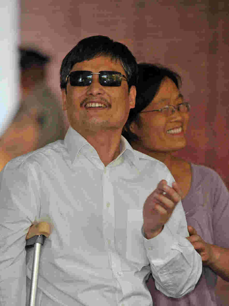Chinese activist Chen Guangcheng and his wife, Yuan Weijing, arrive at an apartment complex in New York on Saturday. A number of Chinese activists have become far less prominent after leaving their homeland, but Chen hopes to continue his work and remain relevant in China.