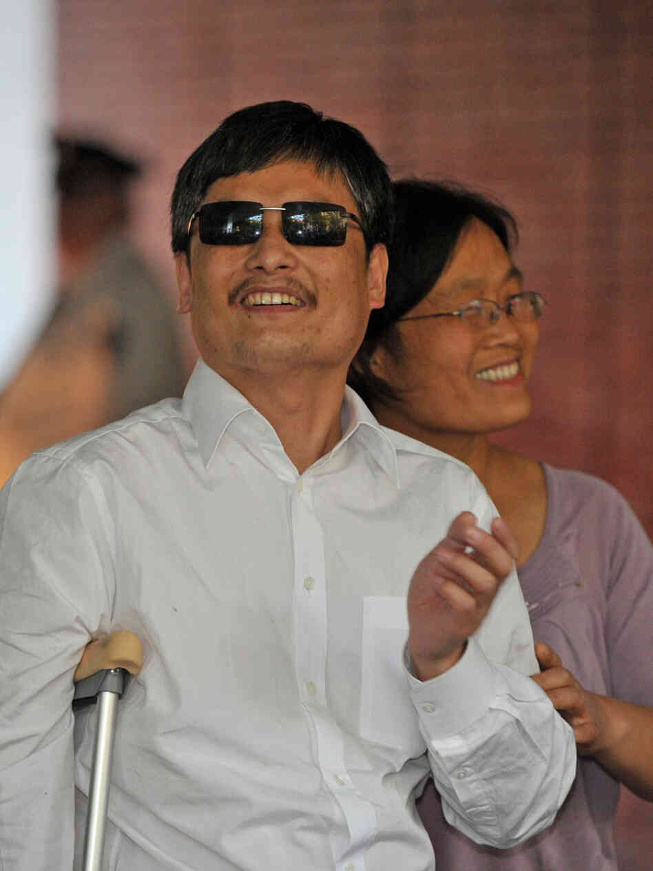 Chinese activist Chen Guangcheng and his wife, Yuan Weijing, arrive at an apartment complex in New York on Saturday. A number of Chinese activists have become far less prominent after leaving their homeland, but Chen hopes to continue his work and remain relevant in China.