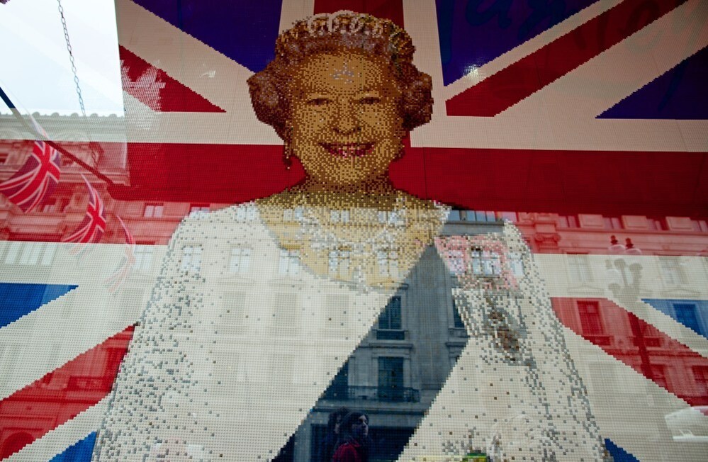 A flag with Queen Elizabeth II's portrait made entierly of Legos is pictured in the window of a shop in central London.