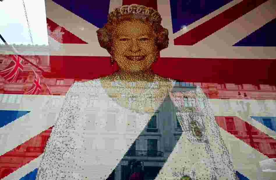 A flag with Queen Elizabeth II's portrait made entierly of Legos is pictured in the window of a shop in central London.