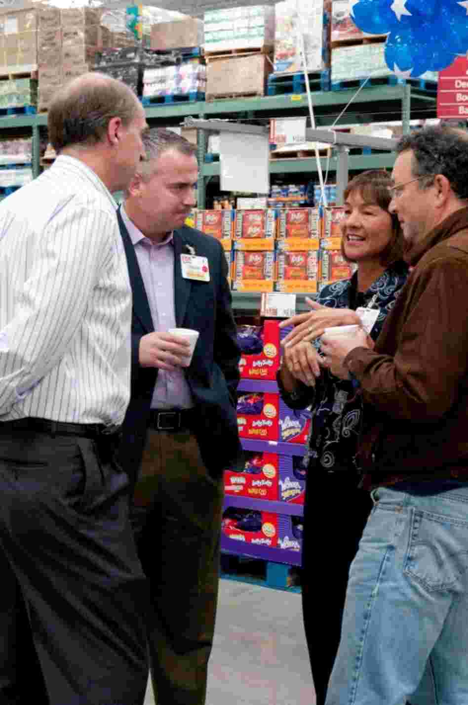Laura Sen talks with team members at the opening of the Northborough, Mass., club in September 2011.