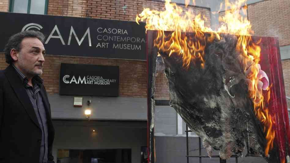Antonio Manfredi, director of the Museum of Contemporary Art in Casoria, Italy, burns an artwork by French artist Severine Bourguignon. Manfredi is burning the museum's works to protest deep cuts to the arts. Antonio Manfredi, director of the Museum of Contemporary Art in Casoria, Italy, burns an artwork by French artist Severine Bourguignon. Manfredi is burning the museum's works to protest deep cuts to the arts.