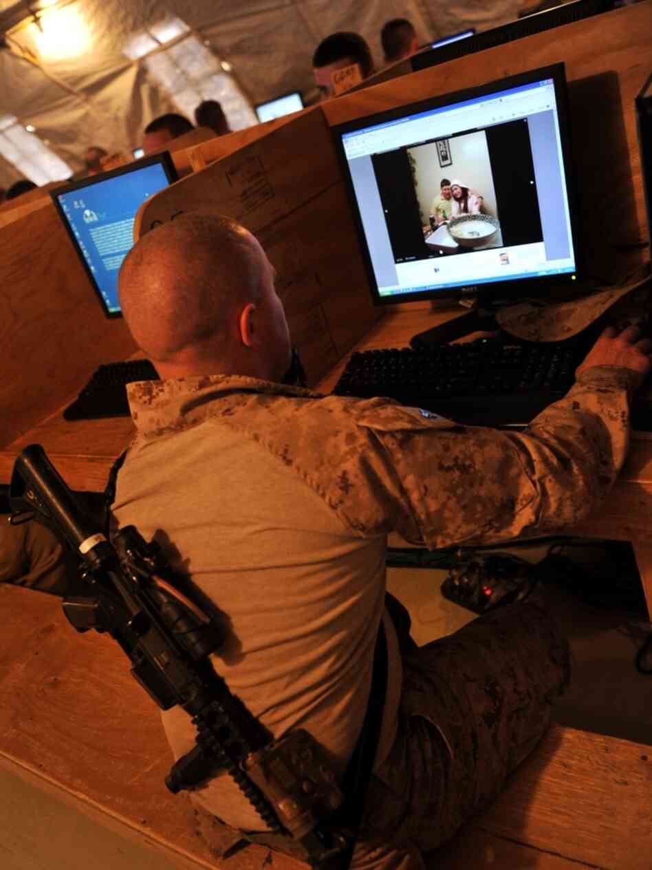 At Forward Operating Base Payne in Afghanistan's Helmand province, Marine Cpl. Jonathan Odriscoll looks at pictures of his sister on Facebook. Troop access to social media has been both a blessing and curse for the military.