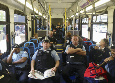 Chicago police officers sit in a bus outside the Boeing headquarters in Chicago on Monday. Chicago police officers sit in a bus outside the Boeing headquarters in Chicago on Monday.
