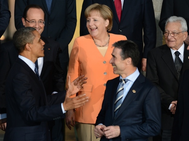 President Obama talks to German Chancellor Angela Merkel, French President Francois Hollande (upper left), NATO Secretary-General Anders Fogh Rasmussen (center) and other leaders during the official photo at Soldier Field in Chicago during the NATO summit Sunday.