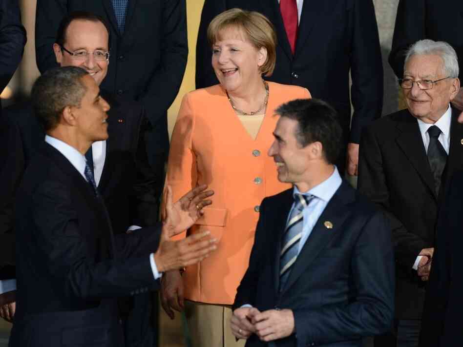 President Obama talks to German Chancellor Angela Merkel, French President Francois Hollande (upper left), NATO Secretary-General Anders Fogh Rasmussen (center) and other leaders during the official photo at Soldier Field in Chicago during the NATO summit Sunday.