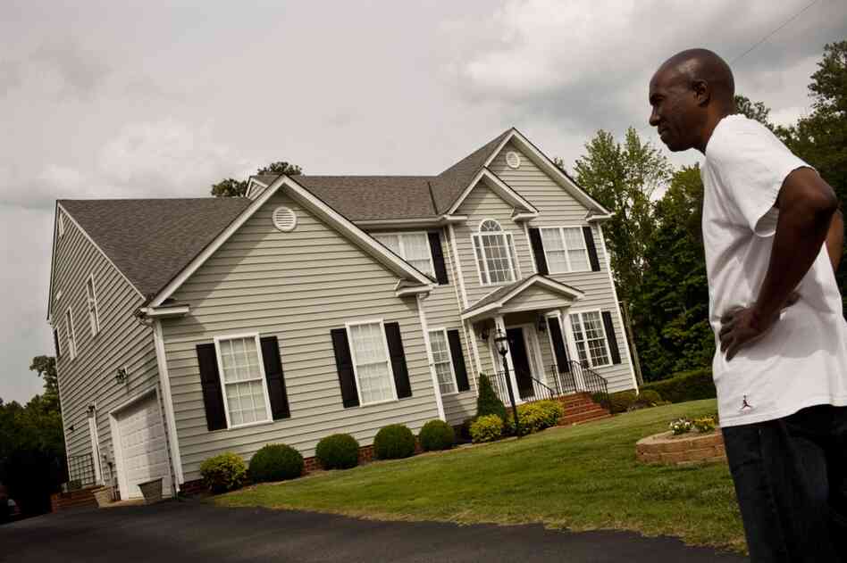 Frank stands outside his home in Glen Allen, Va., which he co-owned with his mother. The family recently sold the home in order to free up money for Ida's care.