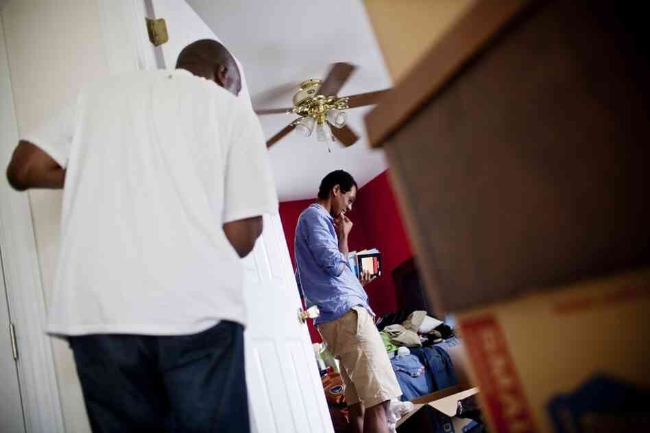 Frank looks on as his son Jonathan, 21, packs his belongings in preparation for their move. "I don't mind the change," Frank says. "I'm a lot like my mother."