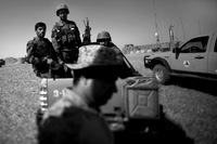 Afghan soldiers on Marjah's outskirts. U.S. Marines will depart in the coming weeks, leaving a skeleton crew to work with Afghan forces.
