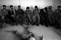 Afghan police watch Marines demonstrate emergency first aid. The top Marine officer in the area says local forces will be prepared to keep the peace.