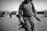 An Afghan policeman carries a rocket-propelled grenade launcher as he leaves for patrol on the outskirts of Marjah, near the Sistani Desert.