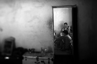 Afghan police meet in a house they use as their headquarters.