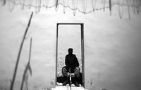 An Afghan policeman guards the entry point to a brand new police station near a busy market.