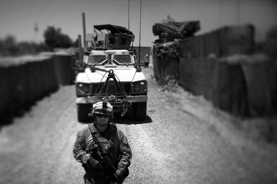 Marines guide an armored vehicle into Marjah's government compound. The Marines meet regularly with police officers and government officials who control the area.