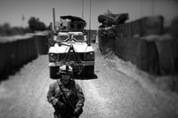 Marines guide an armored vehicle into Marjah's government compound. The Marines meet regularly with police officers and government officials who control the area.
