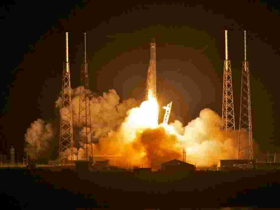 SpaceX's Dragon capsule, atop the company's Falcon 9 rocket, as it blasted off before dawn this morning in Florida.
