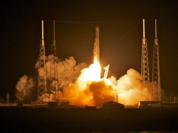 SpaceX's Dragon capsule, atop the company's Falcon 9 rocket, as it blasted off before dawn this morning in Florida.