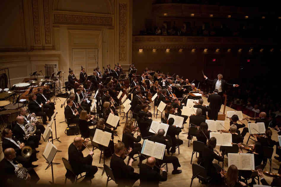The Cleveland Orchestra's concert at Carnegie Hall on May 23, 2012 was originally scheduled to include Shostakovich's Symphony No. 6, Kaija Saariaho's 'Laterna Magica,' and Brahms' Piano Concerto No. 2 with Yefim Bronfman. However, after Bronfman cancelled due to illness about 24 hours before concert time, violinist Gil Shaham stepped in to play the Brahms Violin Concerto. 