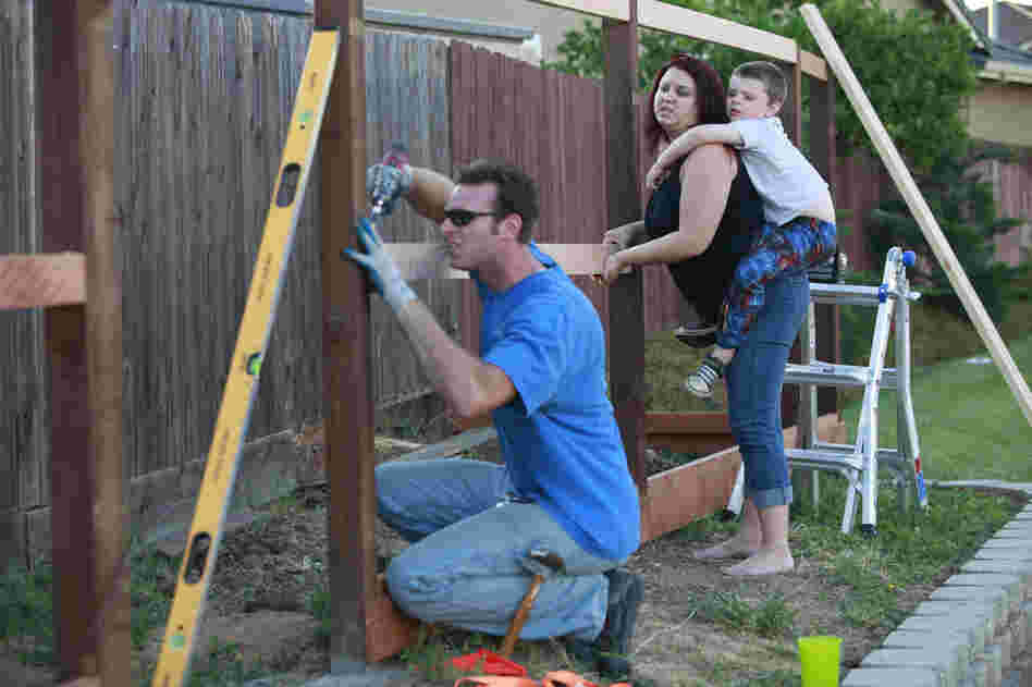 After coming home from his job, Kevin works on a fence he is building around their home. The Coopers have stopped taking trips, eating out and spending money on anything else they don't need.