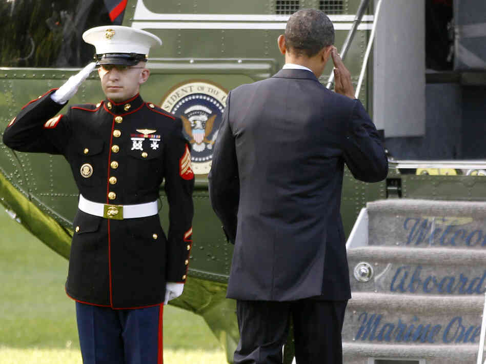 President Obama returns a Marine's salute as he boards the Marine One helicopter Wednesday. Obama traveled to Colorado Springs for the U.S. Air Force Academy graduation ceremony.