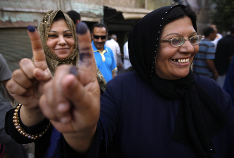Two women show their inked fingers after casting their votes on the first day of the Presidential election at a polling center in Old Cairo, Egypt, on Wednesday. Two women show their inked fingers after casting their votes on the first day of the Presidential election at a polling center in Old Cairo, Egypt, on Wednesday.