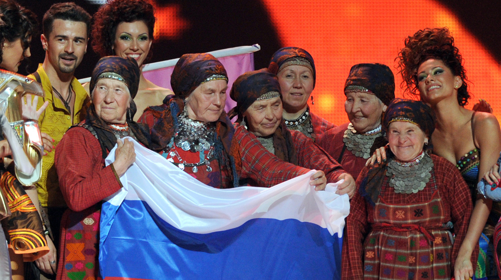 Russia's singing group Buranovskiye Babushki hold their national flag as they celebrate making it through to the Eurovision final on May 22 with Moldova's entrant, Pasha Parfeny (left), and his dancers.