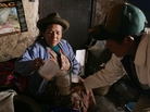 A woman serves a glass of 'Chicha' to a client in the village of Pisaq near Cuzco, Peru. Chicha is a local alcoholic beverage made from sprouted or germinated corn. A woman serves a glass of 'Chicha' to a client in the village of Pisaq near Cuzco, Peru. Chicha is a local alcoholic beverage made from sprouted or germinated corn.