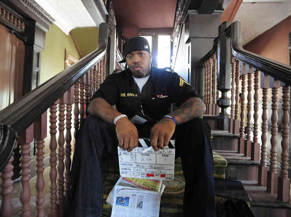 Baltimore Ravens linebacker Terrell Suggs holds a slate.