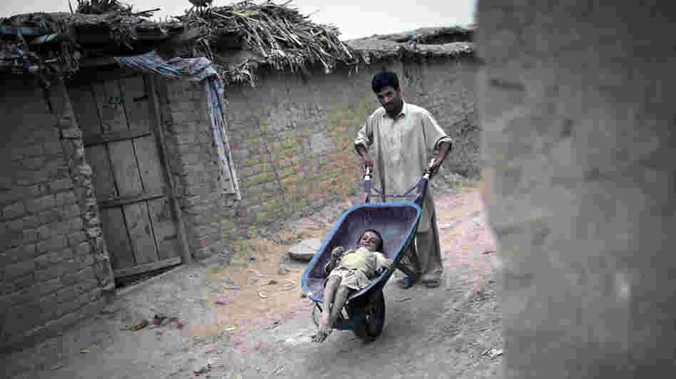 A Pakistani man wheels Jamshid, an 8-year-old girl with polio, around the outskirts of the capital Islamabad last July. A Pakistani man wheels Jamshid, an 8-year-old girl with polio, around the outskirts of the capital Islamabad last July.