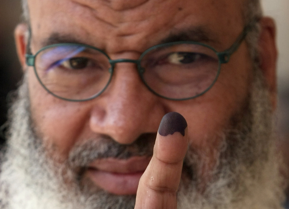 An Egyptian man shows his ink-stained finger after voting in Cairo earlier today.
